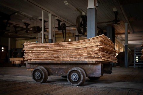 Wagon on rails for transporting cardboard, former paper factory and mill for the production of