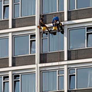 Two male glass cleaners abseiling down the hotel façade to clean windows, aletto Hotel Kudamm,