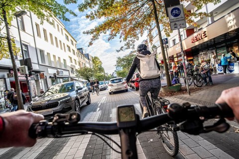 Cycling in the city, city centre road, cycle lane, two-wheeled traffic has priority, 30 km/h zone,
