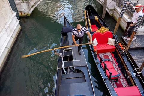 Venice, Italy - 3 September 2025: Gondolier on a gondola in Venice during the 82nd Venice