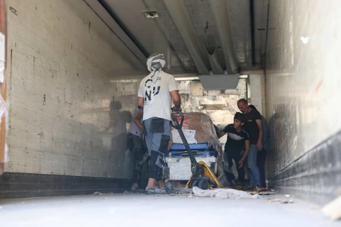 Relief workers unload boxes of medical aid provided by Qatar at Damascus International Airport,