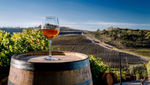 Glass of 10-year-old tawny wine placed on a barrel in a vineyard restaurant, AI generated