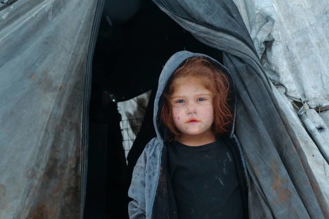 Displaced Syrian families and children living in refugee camps during harsh winter conditions,