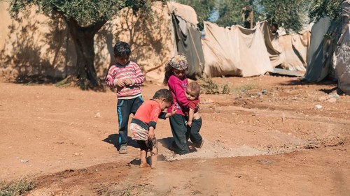 Syrian children playing in a refugee camp near the Turkish border on World Children's Day. Aleppo,