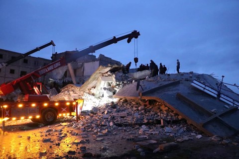 Civil defense teams attempt to rescue civilians trapped under the rubble after a powerful