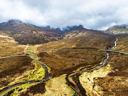 Eas a' Bhradain Waterfall from drone, Red Cuillin mountains, Loch Ainort, Isle of Skye, Scotland,