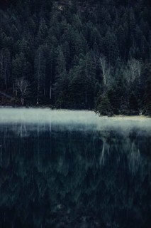 Sunrise with reflections in the Plansee in Tyrol in the Alps in Austria