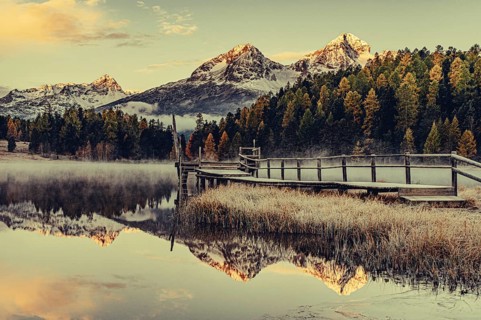 Lake Staz near Sankt Moritz in the Engadin in Switzerland. Morning atmosphere with fog in autumn.
