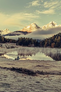 Lake Staz near Sankt Moritz in the Engadin in Switzerland. Morning atmosphere with fog in autumn.