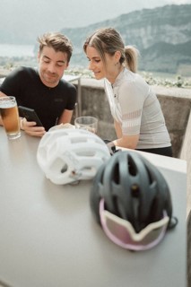Young man taking a coffee break while riding his racing bike on Lake Garda. Sunny weather and dolce