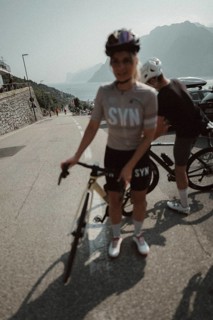 Woman and man riding racing bikes in Italy on Lake Garda