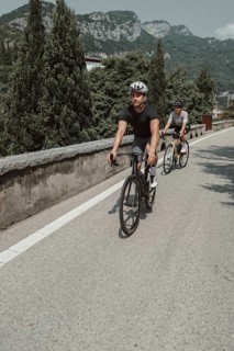 Woman and man cycling on Lake Garda in Italy. Sunny weather and dolce vita