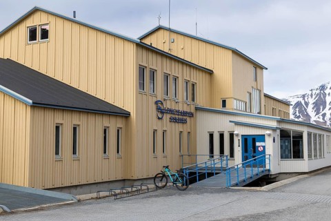 Hospital, yellow wooden house, Longyearbyen, Spitsbergen, Svalbard