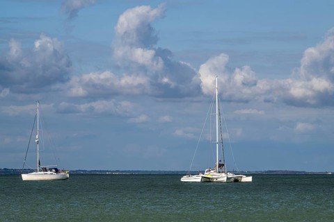 Boats on sea over Knoll Beach Studland, Poole, Dorset, England, United Kingdom