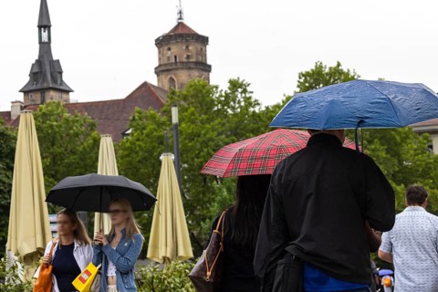 Rainy weather in Stuttgart. People with umbrellas hurry through the rain on Königstraße. Stuttgart,