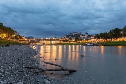 The city of Salzburg with the Salzach shines in the first light of summer morning