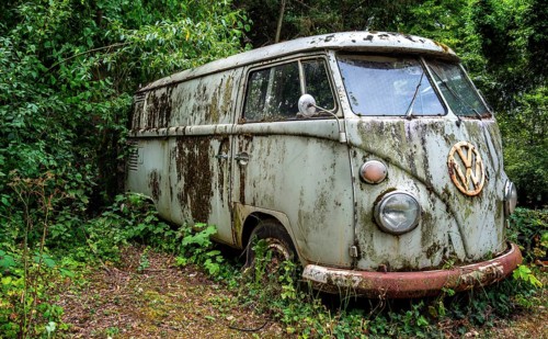 Old, weathered VW bus parked in a wooded area, Hesse, Germany