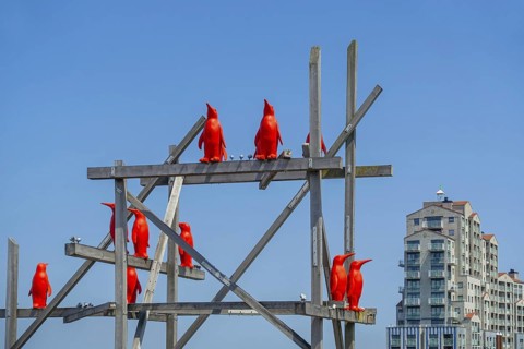 Rode Pinguins, Red Penguins, artwork by Belgian artist William Sweetlove in the harbour of Breskens