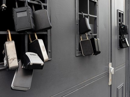 Key boxes on a grille of a basement window for flat flats in the city centre of Bratislava,
