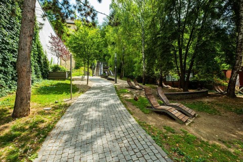 Small park with seating, a playground and a fountain at the entrance to Trencin Castle, Capital of