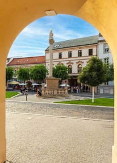 Alley with a view of the square and the Plague Column in the historic centre of the Capital of