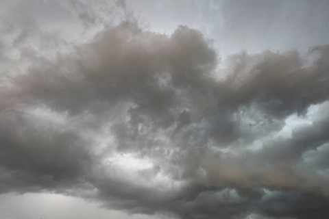 Dark discoloured storm clouds Cloud roll above grey clouds Rain clouds herald thunderstorms,