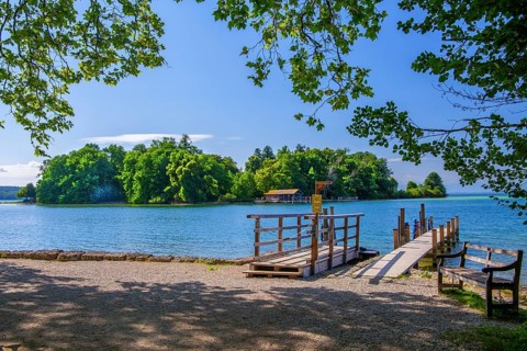 Bell jetty on the lakeshore with a view of Roseninsel in Lake Starnberg, Feldafing, Upper Bavaria,