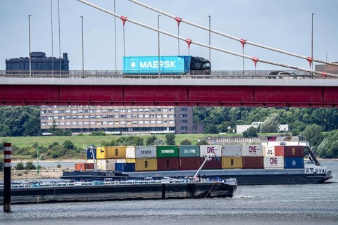 Barges on the Rhine at Ruhrort harbour, container freighter on uphill journey,