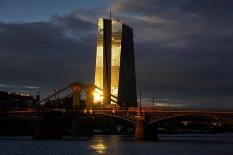 The light of the setting sun is reflected on the glass façade of the European Central Bank (ECB) in