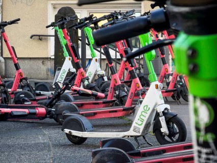 Many rental e-scooters parked on a pavement in Wuppertal, Germany