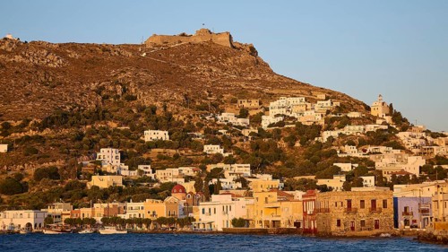 Panteli Fortress, Greek village on a hillside at dusk, historic buildings in front of a fortress