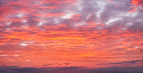 Background image for sky replacement, evening sky with illuminated red clouds at dusk after sunset