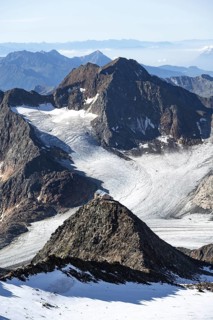 At the Wilder Freiger summit, picturesque high mountain landscape with snow, view of the