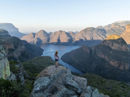 Hiker enjoying panorama, Blyde River Canyon with summit Three Rondawels, view of canyon with river