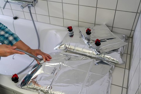 Filling a 10 litre water bag, for storing drinking water at home, as an emergency reserve in the