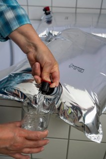 Tapping water from a 10 litre water bag, for storing drinking water at home, as an emergency