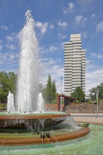 Round torch fountain by Friedrich Korter 1939 and town hall, water fountain with water basin, water