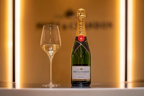 Bottle of Champagne Impérial Brut, filled glass, logo, lettering, headquarters of the champagne