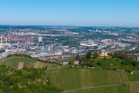 Panoramic picture of a cityscape with a building on a vineyard hill, view of the burial chapel of