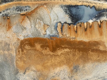 Abstract saline patterns at the edge of the Walvis Bay salt works. Aerial view. Drone shot. Namibia