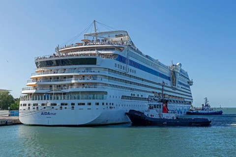 Cruise ship AIDA nova is pushed against the quay wall by tugboats, Warnow, Warnemünde, Rostock,