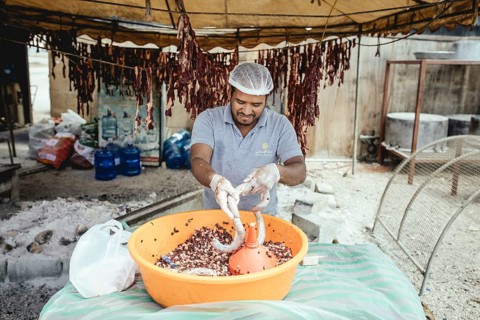 Traditional camel restaurant in Salalah, stuffing camel sausages, Dhofar, Oman