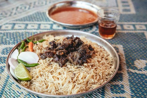 Traditional camel restaurant in Salalah, dry braised camel meat on rice, Dhofar, Oman