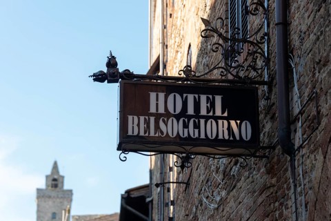 Wrought iron sign of the Hotel Belsoggiorno in San Gimignano, Tuscany, Italy