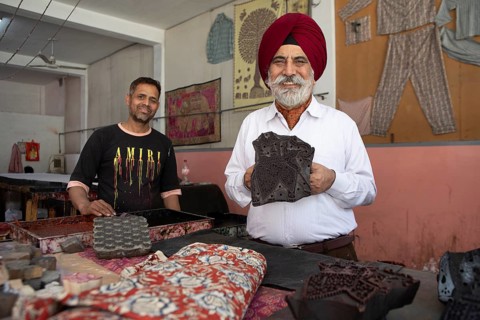 Indian men showing wooden panels for woodblock printing, Jaipur, Rajasthan, India