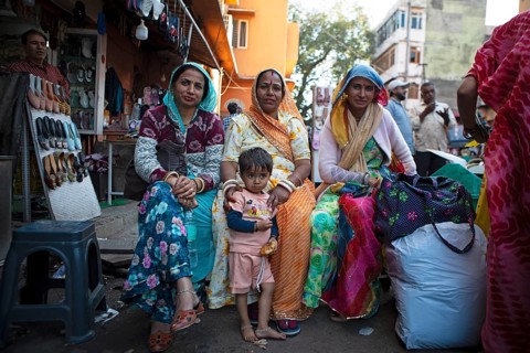 Indian woman in colourful saris and a child in the old town, Jaipur, Rajasthan, India