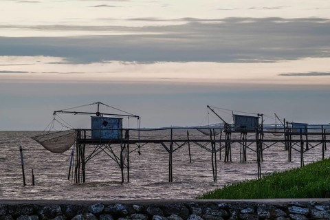 Sunset over Fishing huts over Randonnee entre Histoire et Nature, Fouras, Fouras-les-Bains,