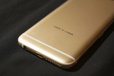 Back of golden smartphone with text Made in China. Concept of globalization and offshore