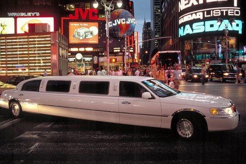 Stretch limousine in Times Square at night, New York City, USA