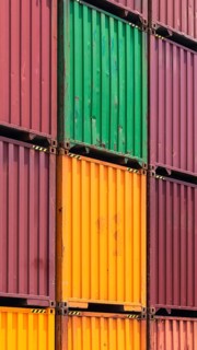 Busy international industrial port with freight and shipment docks and cargo containers